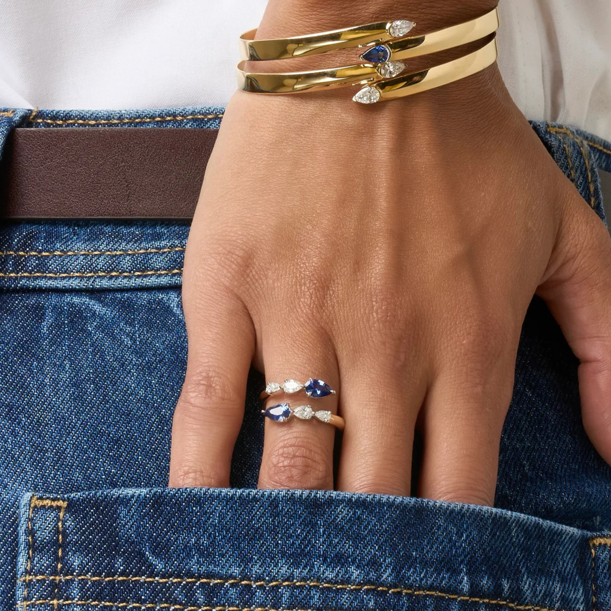 Pear Shape Diamond and Blue Sapphire Graduated Crossover Ring